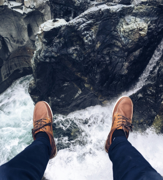 Guy jumping into a raging river